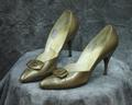Pumps of light bronze leather with pointed toe and decorative accent on vamp