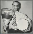 Dr. Edwin Yunker holding cathode tubes used in radar