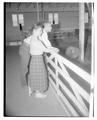 Students Gayle Davidson and Leroy Martin posing in a sheep barn
