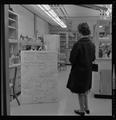 Visitor looking at lab equipment in Weniger Hall, Fall 1962