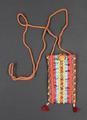 Pouch of woven clay-red cotton or linen, fully covered with various ribbon trims in reds, metallic gold, blue, yellow, purple, green, and black