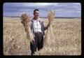 Dr. Charles Rohde holding grain at Pendleton Branch Experiment Station, 1966