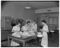 Women students evaluating butter in Withycombe Hall, April 1952