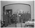 ROTC students and President Jensen posing with summer camp trophies, September 1961