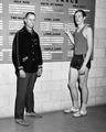 Coach Berny Wagner and Dick Fosbury next to track records board