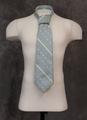 Tie of light blue polyester with ivory diagonal stripes spaced between two diagonal lines of dots in ivory