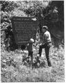 Man and boy reading signage about 1962 storm