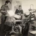 Two CPS men operating printing press