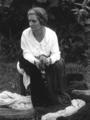 Mrs. Arema Stone Viner, seated with yarn