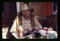 Reub Long and Dean Frischknecht eating dinner in camper, Lake County, Oregon, circa 1972