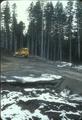 logging equipment on dirt road--snow