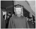 A graduate standing outside of the coliseum on commencement day, June 1959