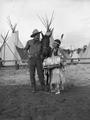 Young Native American woman with cowboy and horse