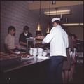 Students serving food in a dining hall