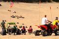 Riders on ATVs and Jeeps in dunes