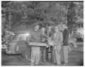 Dean Paul Dunn at OSC accepting chain saw gift, December 1954