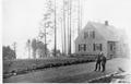 Ranger's residence, 2 men facing camera and standing on dirt road. Series of 2. See 02-133