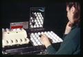 Worker candling eggs at Allen Tom Poultry Farm, Rufus, Oregon, May 23, 1970
