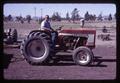 Unidentified man on tractor at Central Oregon Branch Experiment Station, circa 1965