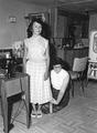 Mary Anne Crocker measures the hem of a skirt for a young homemaker on the Warm Springs Indian Reservation