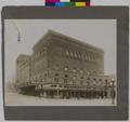 Heilig Theater, at corner of Broadway and Taylor, Portland. Shops along Taylor in foreground.