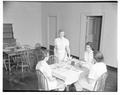 Home Economics students at a formal table setting, January 1954