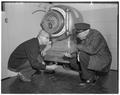 Inspecting vault in Administration Building after safecrackers made an unsuccessful attempt to crack it, January 1962