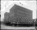 Heilig Theater, at corner of Broadway and Taylor, Portland. Shops along Taylor in foreground.