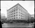 Henry Building at 4th and Oak, Portland. Autos parked outside building. Bookstore and Loan Office visible on ground floor.