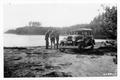 E. A. Sherman, C. J. Buck, Ralph Shelley examine paper (possible map) while standing beside car (1930�s). Lake in background. See Series 02-001 through 02-018, and 02-131