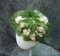 Hat of green net with pale pink fabric flowers with green fabric leaves