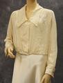 Blouse of ivory silk crepe with elongated spread collar trimmed in a tiny stitched lace