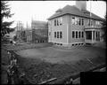 Ainsworth School, Portland, with additional wing under construction; framing stage. Front corner view of original building in foreground, new wing in background.