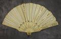 Folding fan of carved ivory with punch-work and open-work in an ornate floral design
