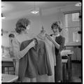 Home Economics students displaying garments in a clothing and textiles research lab, February 1964