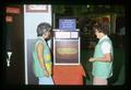 Women For Agriculture participants watching food prices slides in Oregon State University exhibit, Oregon State Fair, Salem, Oregon, 1974