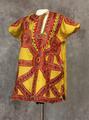 Tunic of yellow silk with silk floss embroidery on front in red with accents of green, black, and white
