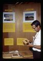 Bob Groner examining straw utilization products, Oregon State Fair, Salem, Oregon, circa 1973