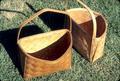 Half baskets 9.5 x 12 x 8 inches at top and 4.25 inches at bottom. Handle 18.5 inches