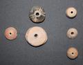 Spindle whorls of carved stone used to make yarn, threads and cords with Aztec designs