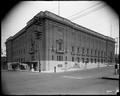 Portland Auditorium at corner of Clay and 3rd. Large urns along sidewalk in front of building.