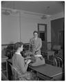 Dr. Fred Winger and a student demonstrate typing techniques using a tachistoscope