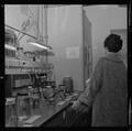 Visitor looking at lab equipment in Weniger Hall, Fall 1962
