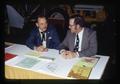 Peter Lyngstrand and Ted Witlich staffing a booth at Pacific International Livestock Expo, Oregon, November 1973