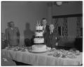 Bob Johnson, President of the Benton County State Bank, observes his 95th birthday with a cake at a Rotary Club meeting, October 18, 1951