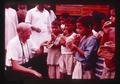 Jim Howard with kids eating chapatis, India, 1979