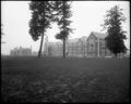 Building on Reed College campus, with two tall trees in front. Other buildings in background.