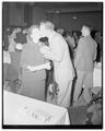 "A proud husband kisses his wife after she had received the Ph.T. (pushed husband through) at annual Engineers day banquet, May 26, 1951"