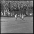 Women playing tennis on the southwestern edge of campus