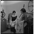 Students examining fabrics in a clothing and textiles research lab, February 1964
